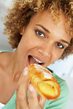 Mid Adult Woman Eating A Pastry