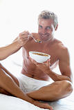 Mid Adult Man Eating A Bowl Of Cereal