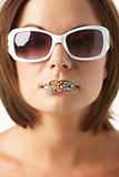Young Woman Wearing Sunglasses With Sprinkles On Her Lips