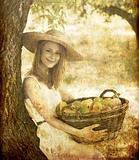 Beautiful redhead girl with fruits in basket at garden.
