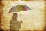 Girl with umbrella at sea coast. Photo in old image style.