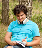 Student with notebook and headphones.