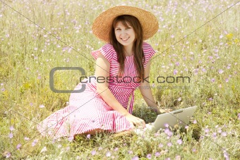Retro style girl at countryside with notebook.