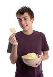 Boy holding potato crisp and smiling