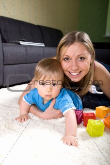 Young mother playing with baby boy 