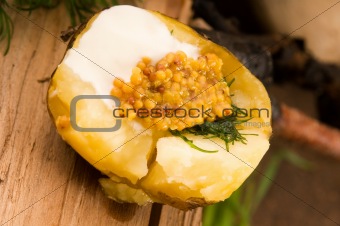Baked potato with sour cream, grain Dijon mustard and herbs