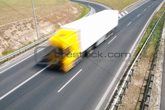 truck is going along the asphalt highway
