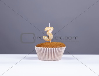 Cake with candle number three at studio isolated.