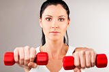 woman is holding barbells