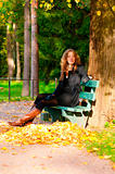 sitting on the bench in autumn park