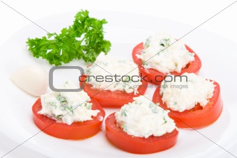 Sliced tomato with cheese and garlic sauce