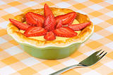 Strawberry and custard tart with dessert fork