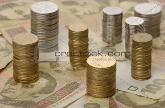 stacks of coins on background of banknotes