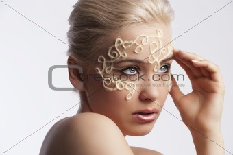 blonde girl with an up-do and wool string decoration