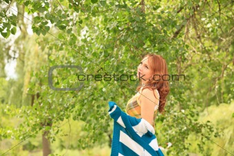 Pretty girl walking through a garden