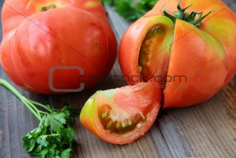 ripe natural tomatoes large size on a wooden table
