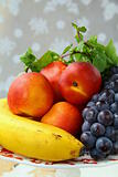 assortment of summer fruits - peaches, apples, grapes, bananas