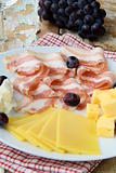 Snack cheese plate with grapes  and smoked bacon