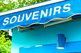souvenirs sign on wet blue surface
