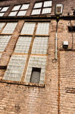 Angle shot of an abandoned industrial building with brick wall