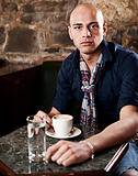 Young man drinking coffee in cafe