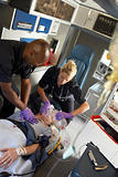 Paramedics performing CPR on patient in ambulance