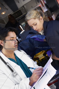 Paramedic advising doctor about arriving patient