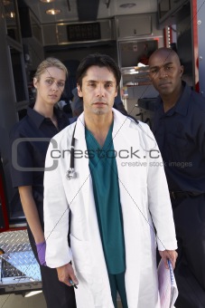 Portrait of doctor with two paramedics in front of ambulance
