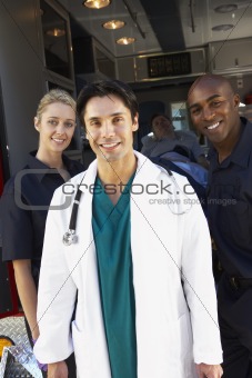 Doctor and paramedics standing in front of an ambulance