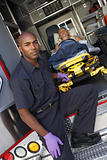 Male paramedic preparing to unload patient from ambulance
