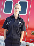 Portrait of paramedic in front of ambulance