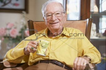 Senior man drinking hot beverage