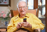 Senior man text messaging