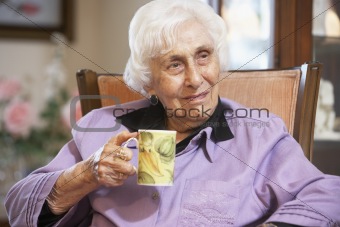 Senior woman drinking hot beverage