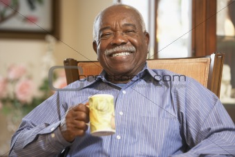 Senior man drinking hot beverage