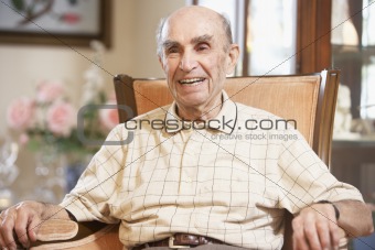 Senior man resting in armchair