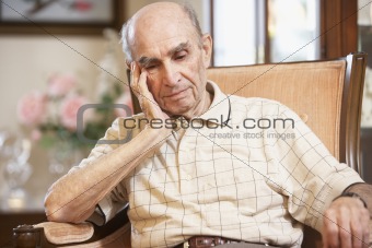 Senior man resting in armchair