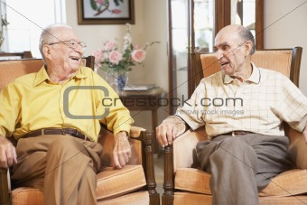 Senior men relaxing in armchairs