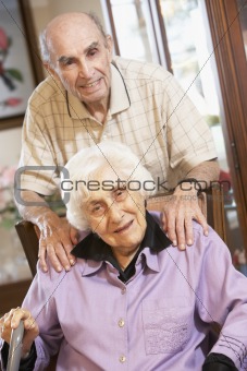 Senior couple relaxing in armchairs