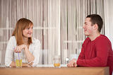 Young couple drinking nonalcoholic drinks in dining room