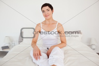 Lovely woman sitting on her bed