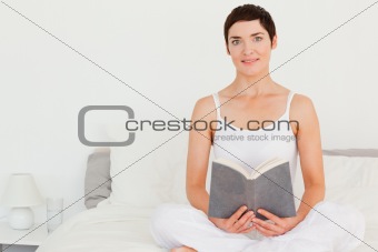 Lovely brunette holding a book