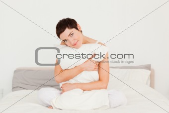 Cute woman holding a pillow