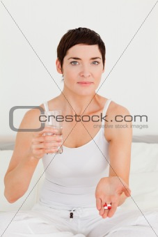 Young woman taking pills