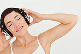 Close up of a lovely brunette listening to music