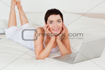 Woman posing with a laptop