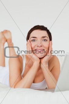 Portrait of a cute woman posing with a laptop