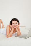 Portrait of a woman listening to music with her laptop