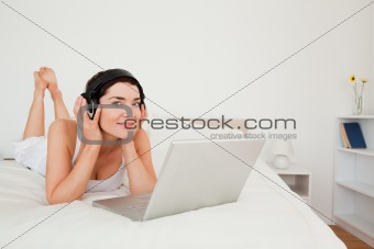 Cute woman watching a movie with her laptop