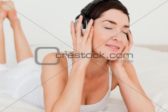 Close up of a brunette listening to music
